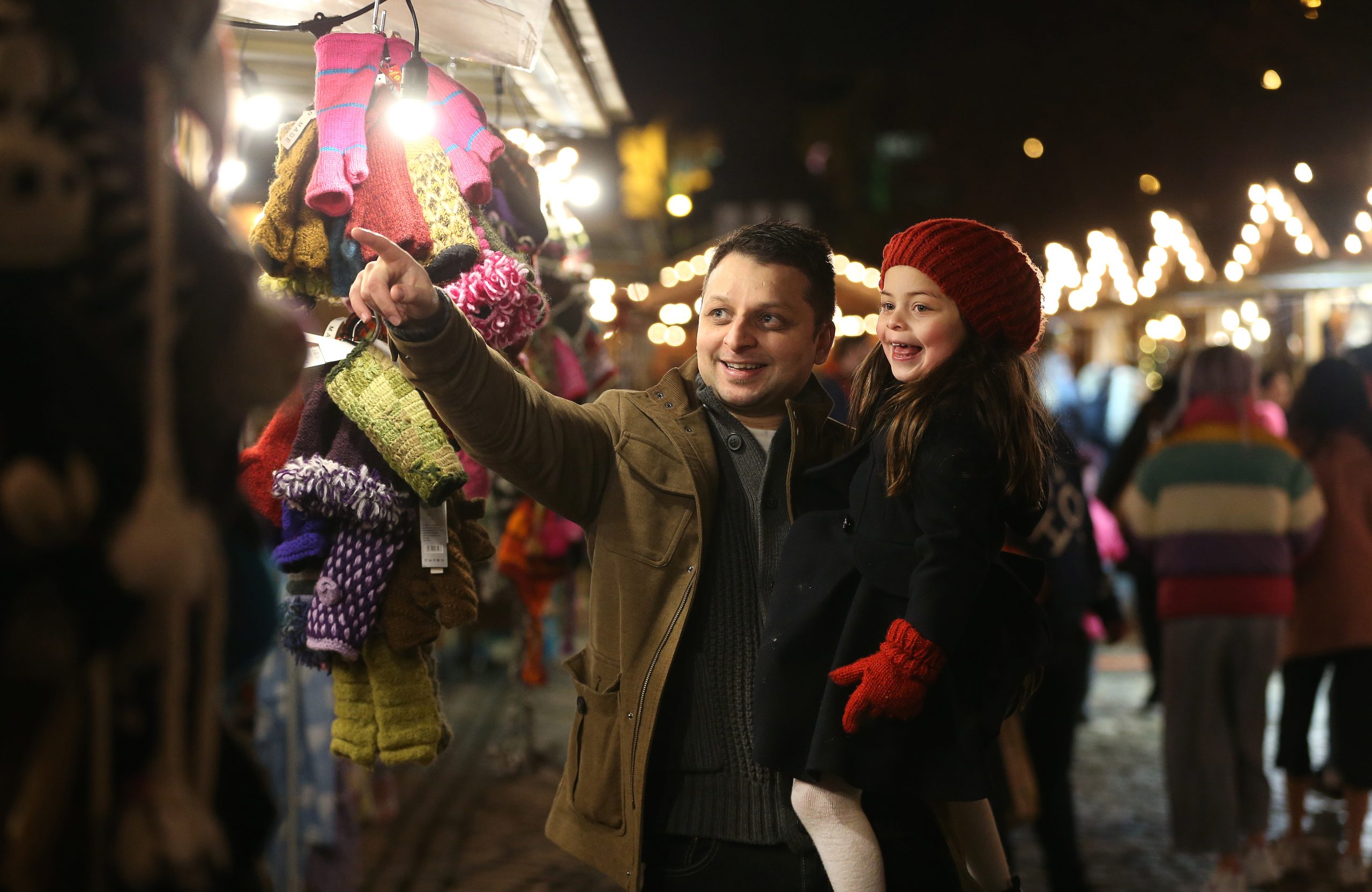 A father and daughter enjoying the Christmas market