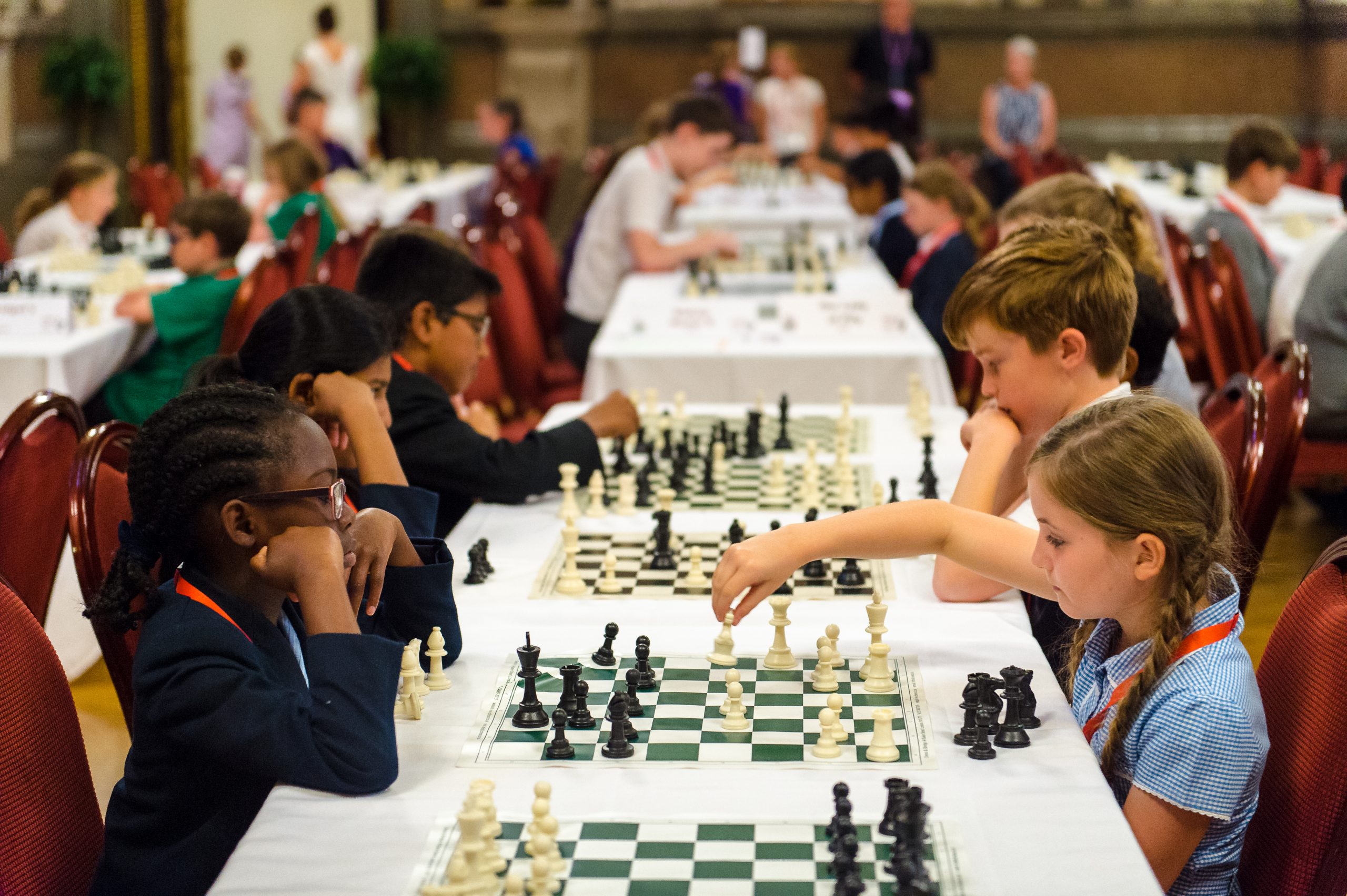A groups of young girls playing chess at St George's Hall, Liverpool
