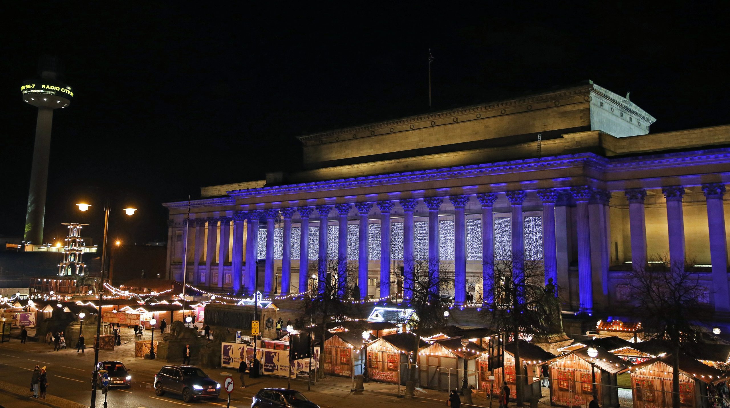 Night image of St George's Hall with Christmas market stalls on the plateau