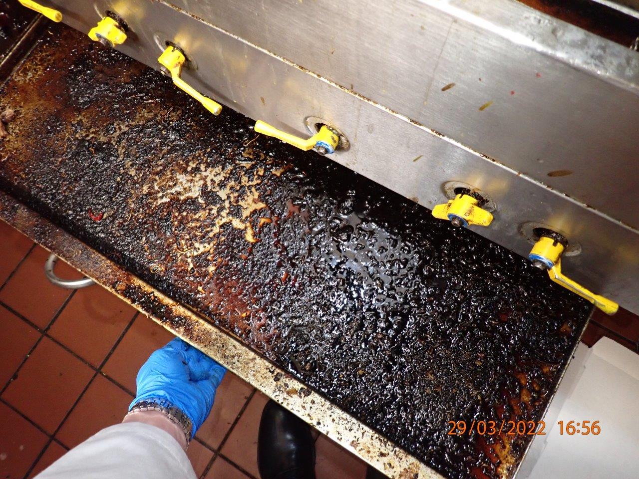 A picture showing a dirty and greasy food preparation surface