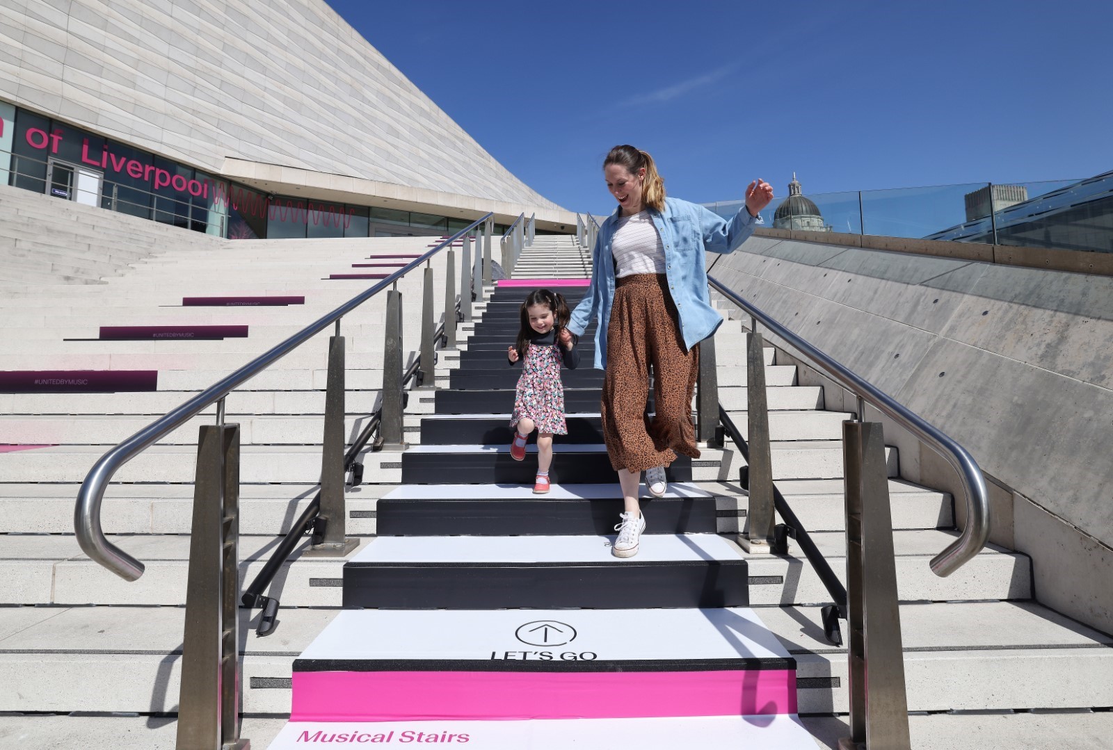 Mum and daughter walking down steps