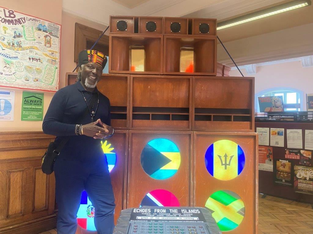 Levi Tefari stood in front of an exhibition