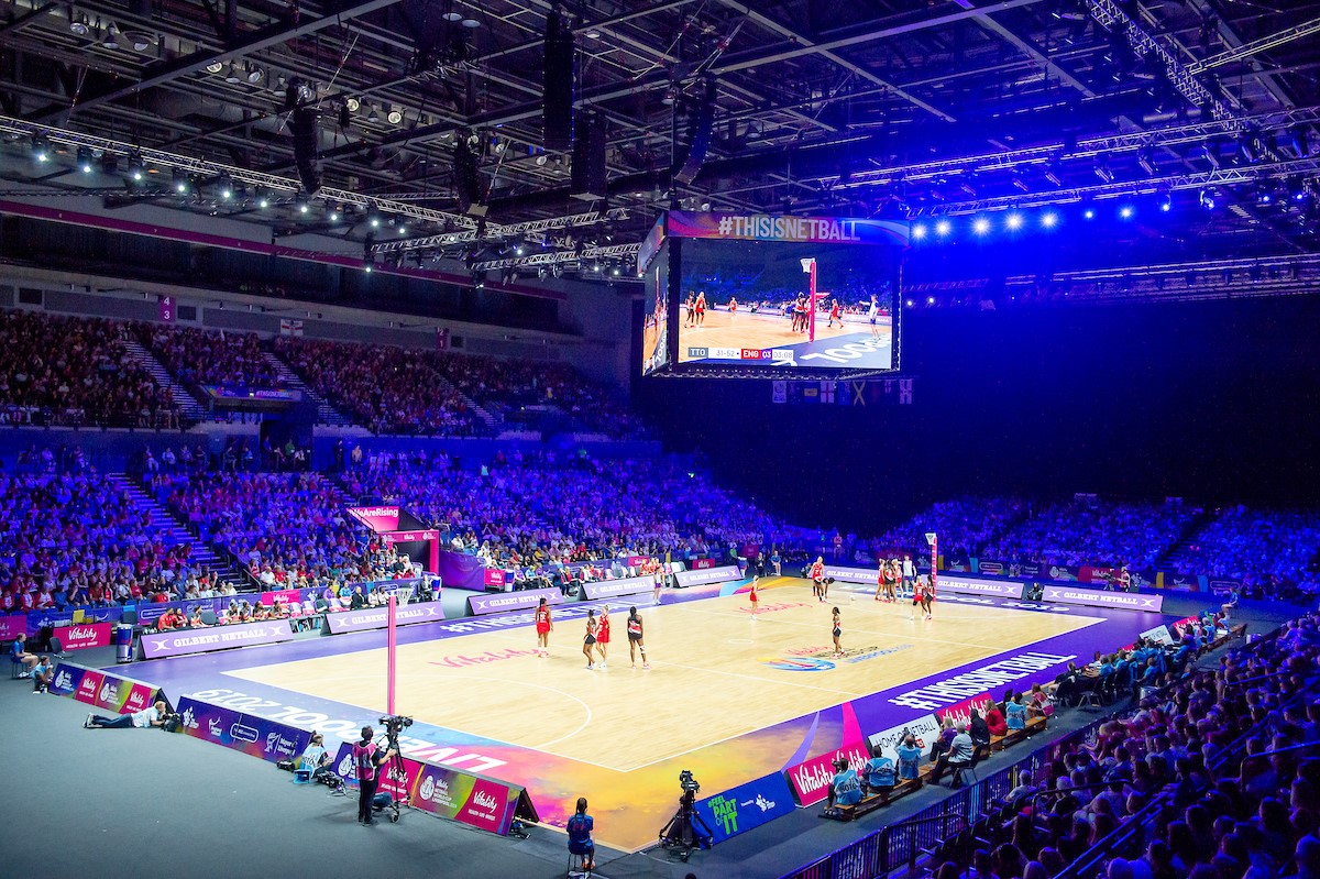 Netball being played inside an arena