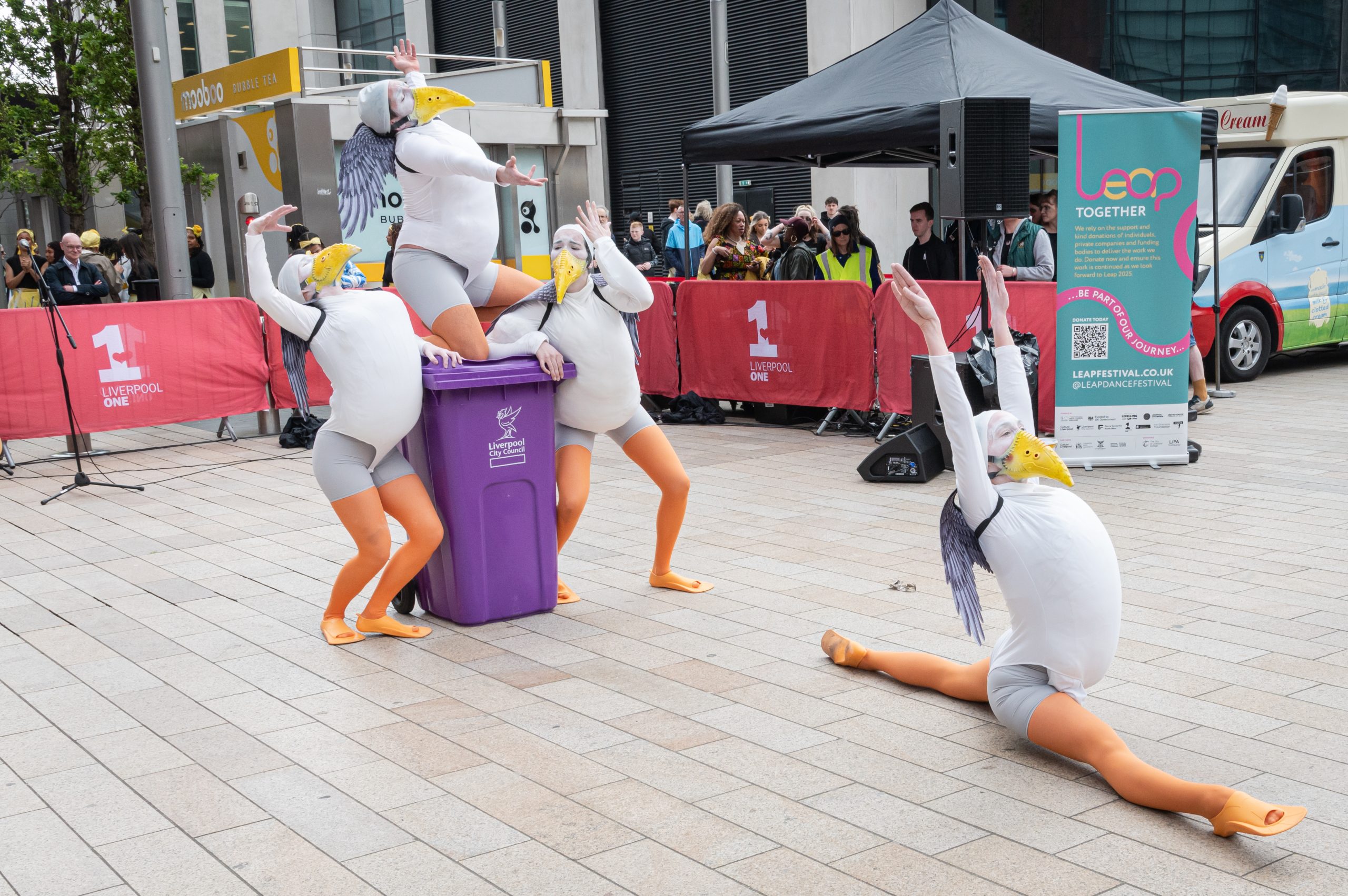 People dressed as seagulls dancing in the street