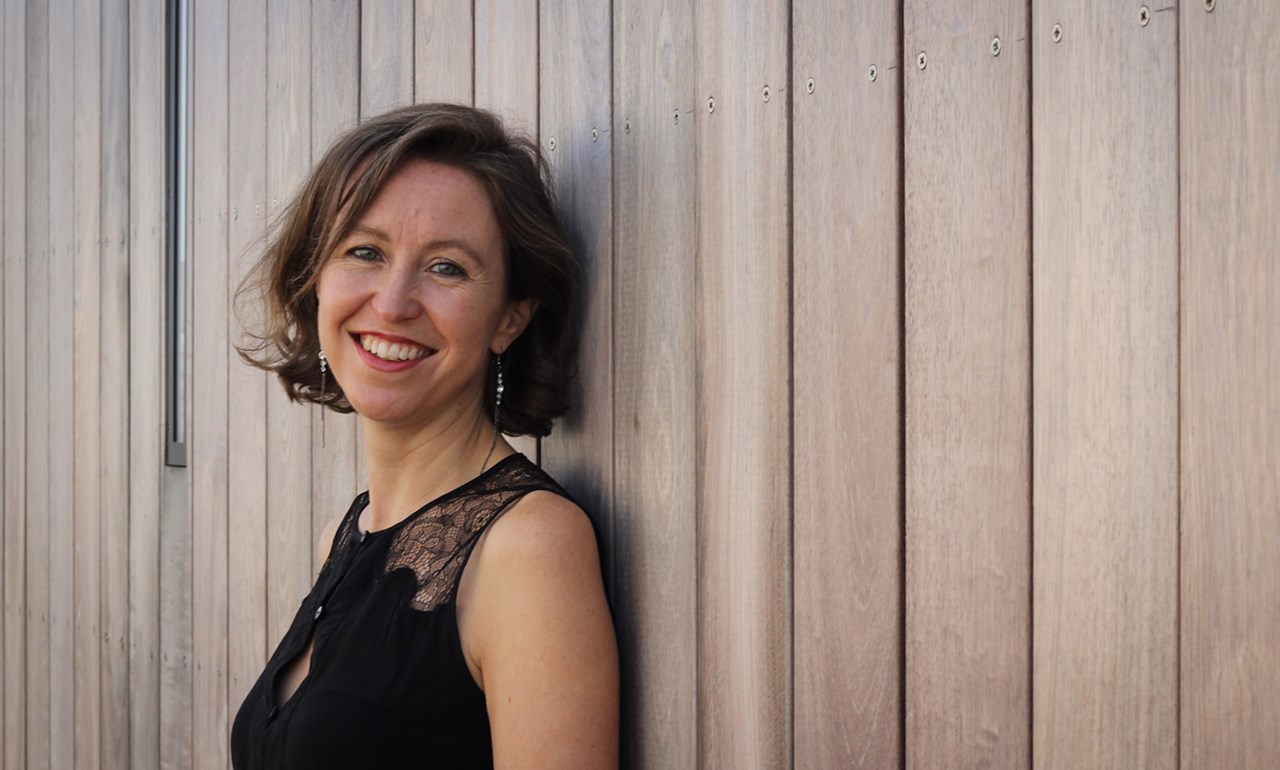 A picture of Vanessa Reed leaning against a white wall