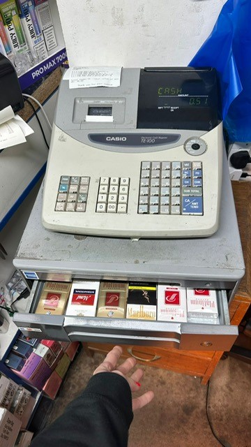 Packets of illicit cigarettes hidden in the drawer of a shop till.