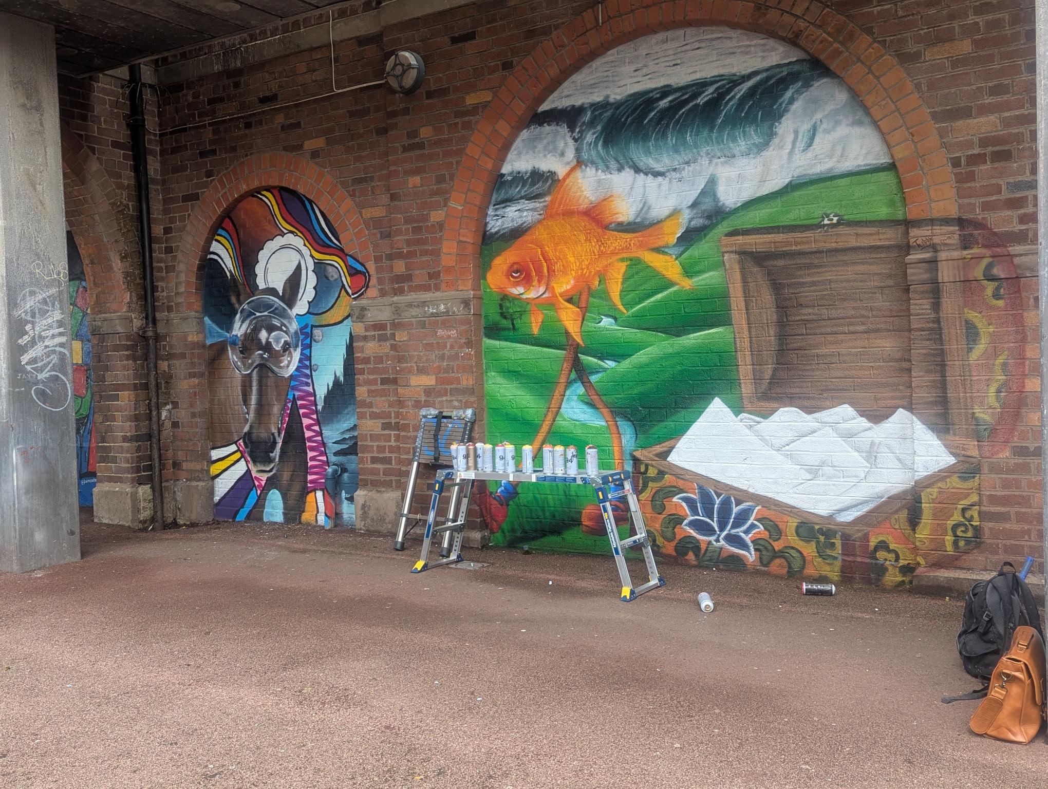 A mural of a horse in space and a fish on stilts