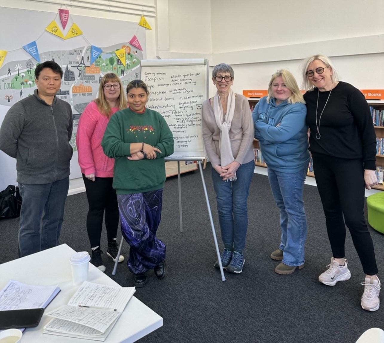 A group of people standing by a whiteboard