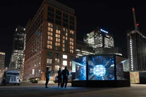 A large glass structure with blue light inside.