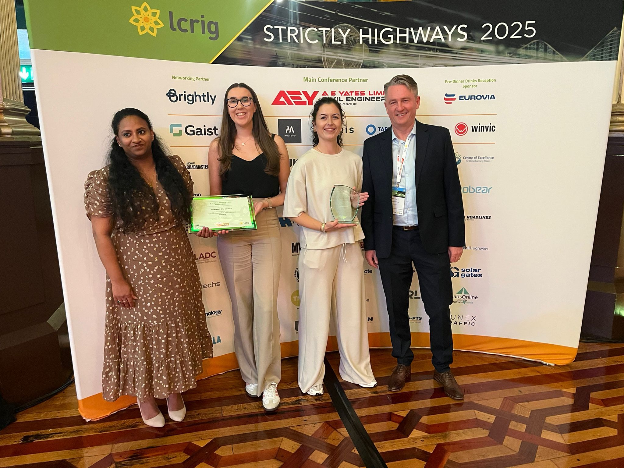 Four people holding an award.